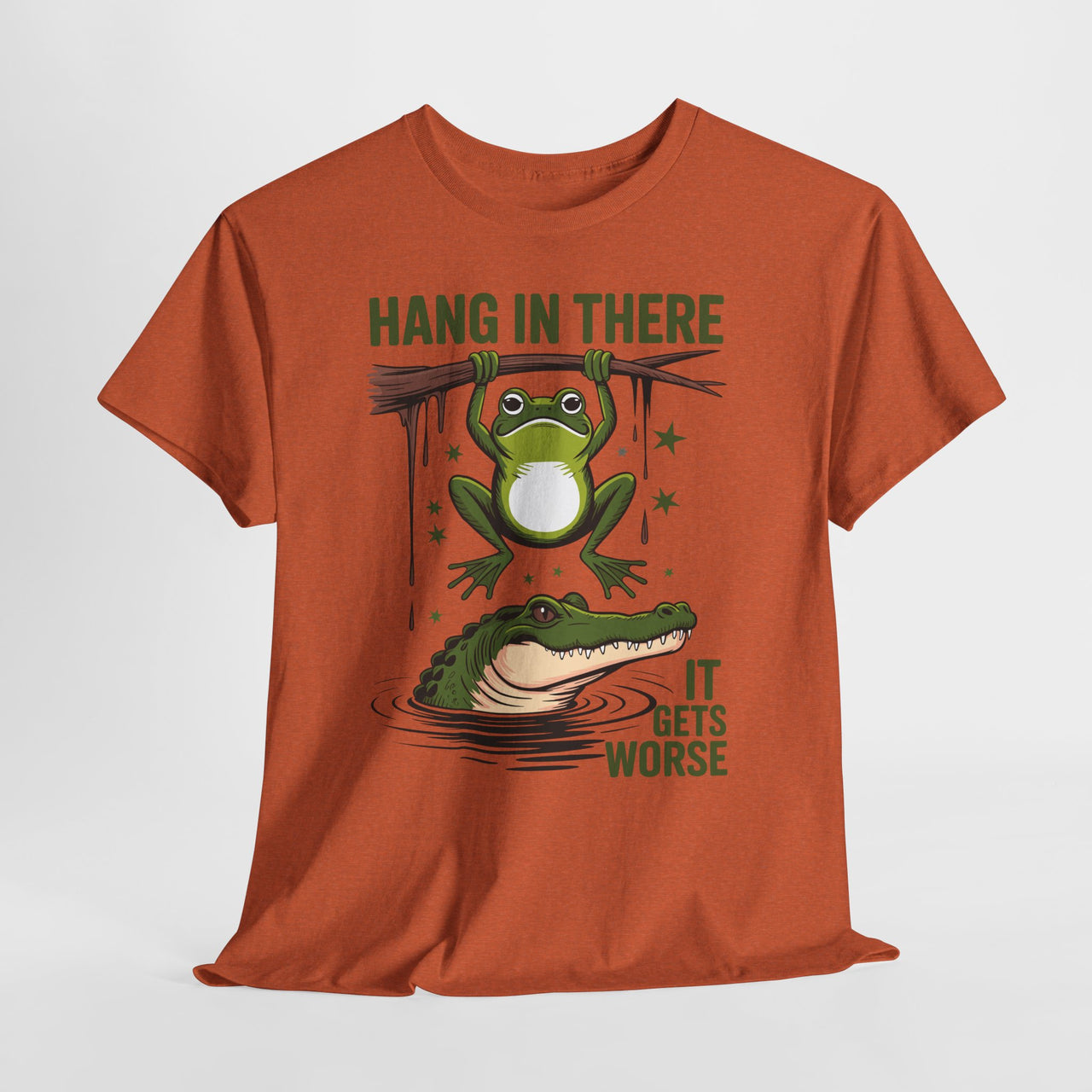 Orange t-shirt with a graphic of a Funny frog hanging from branch over alligator graphic – Hang In There It Gets Worse shirt on a white background.