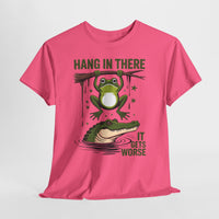 Pink t-shirt with a graphic of a frog and alligator with text 'Hang in there, it gets worse' on a white background.
